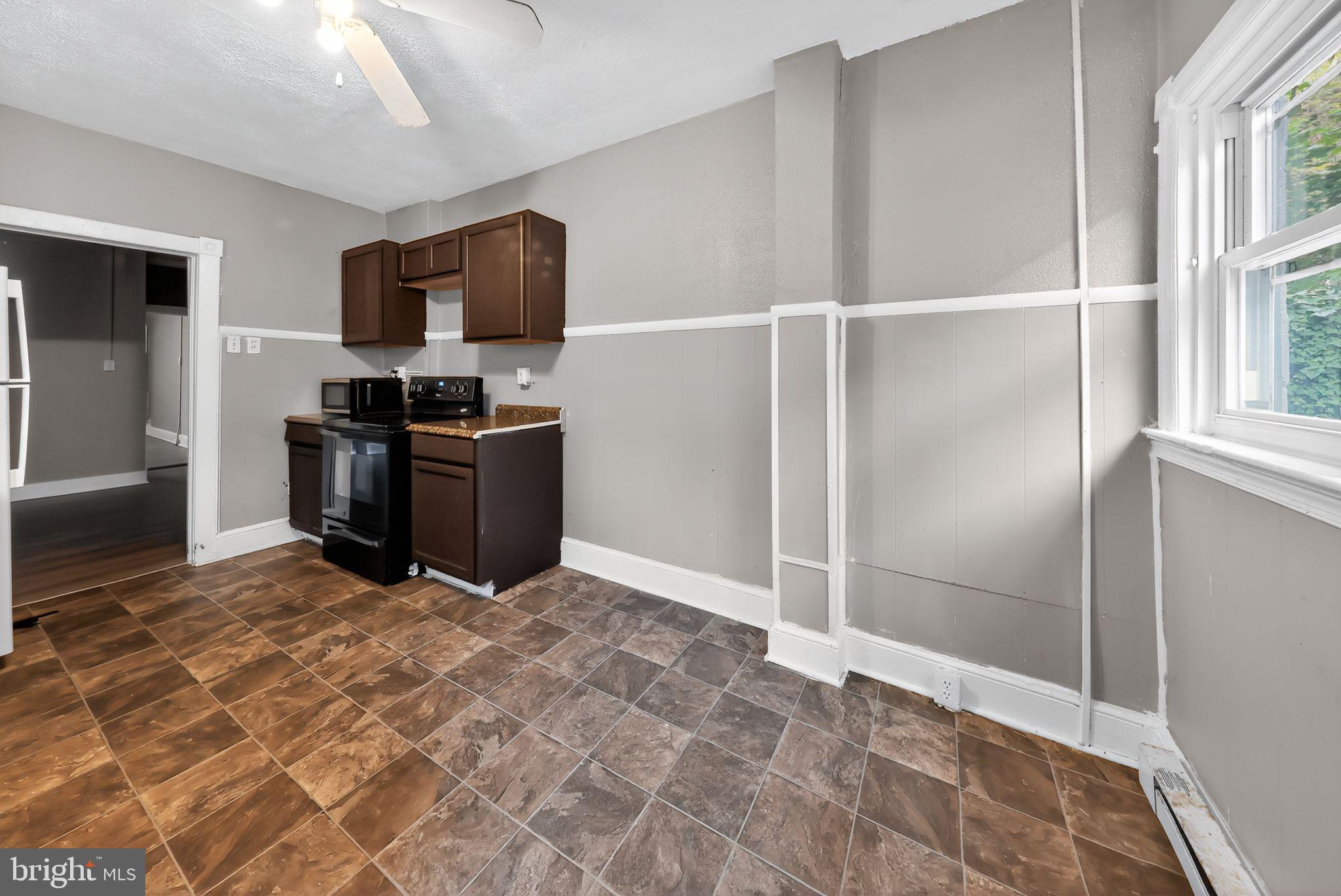 11 East 24th Street Wilmington, DE 19802 - Photo 17 of 31 a view of a kitchen with microwave and cabinets