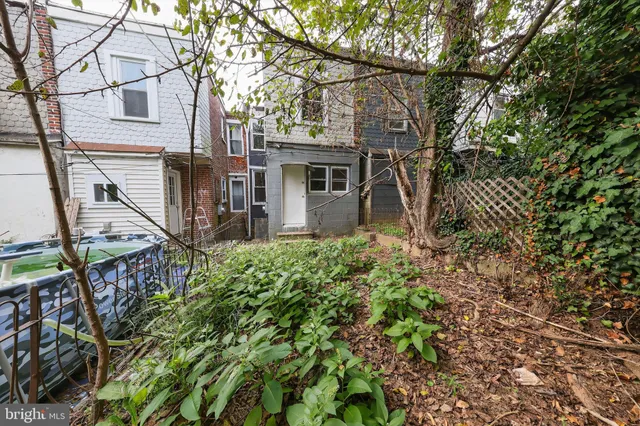a view of a house with a tree and a yard