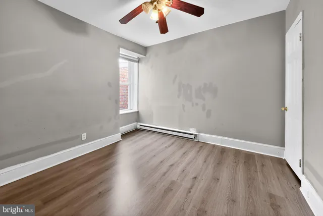 wooden floor in an empty room with a window