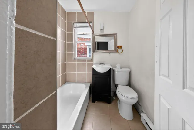 a white toilet sitting next to a bathroom sink