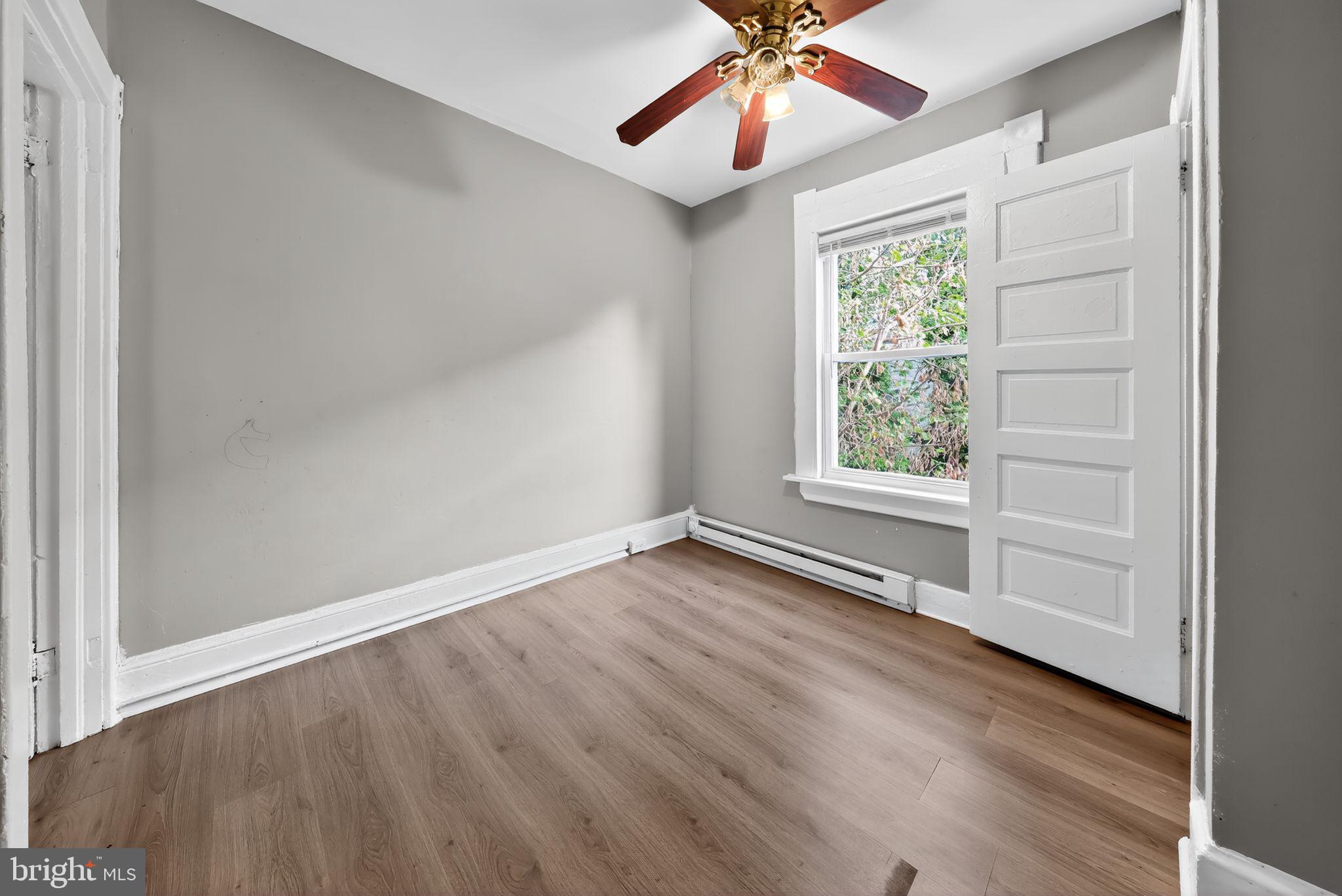 11 East 24th Street Wilmington, DE 19802 - Photo 31 of 31 an empty room with wooden floor chandelier fan and windows