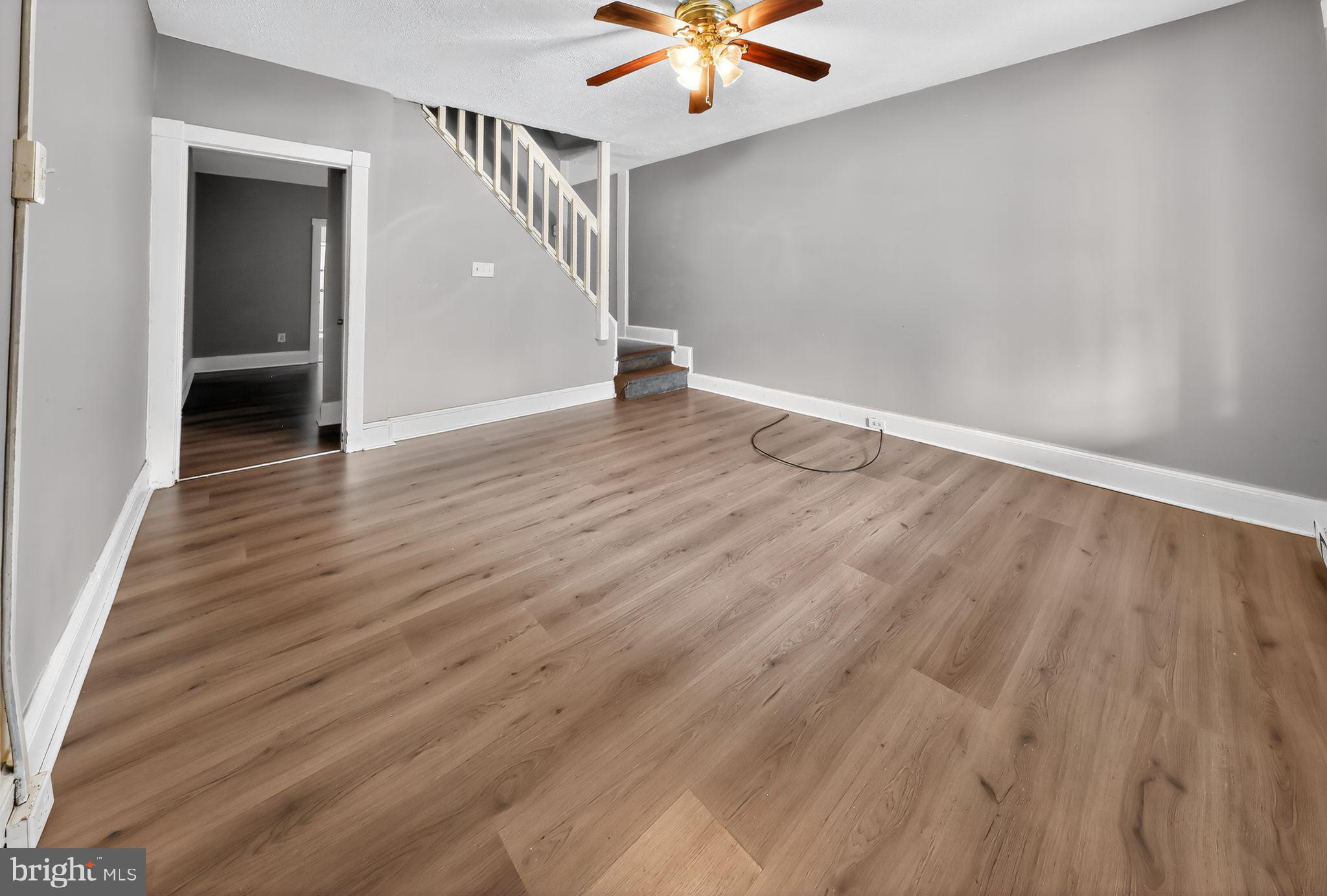 11 East 24th Street Wilmington, DE 19802 - Photo 6 of 31 a view of an empty room with wooden floor and a ceiling fan