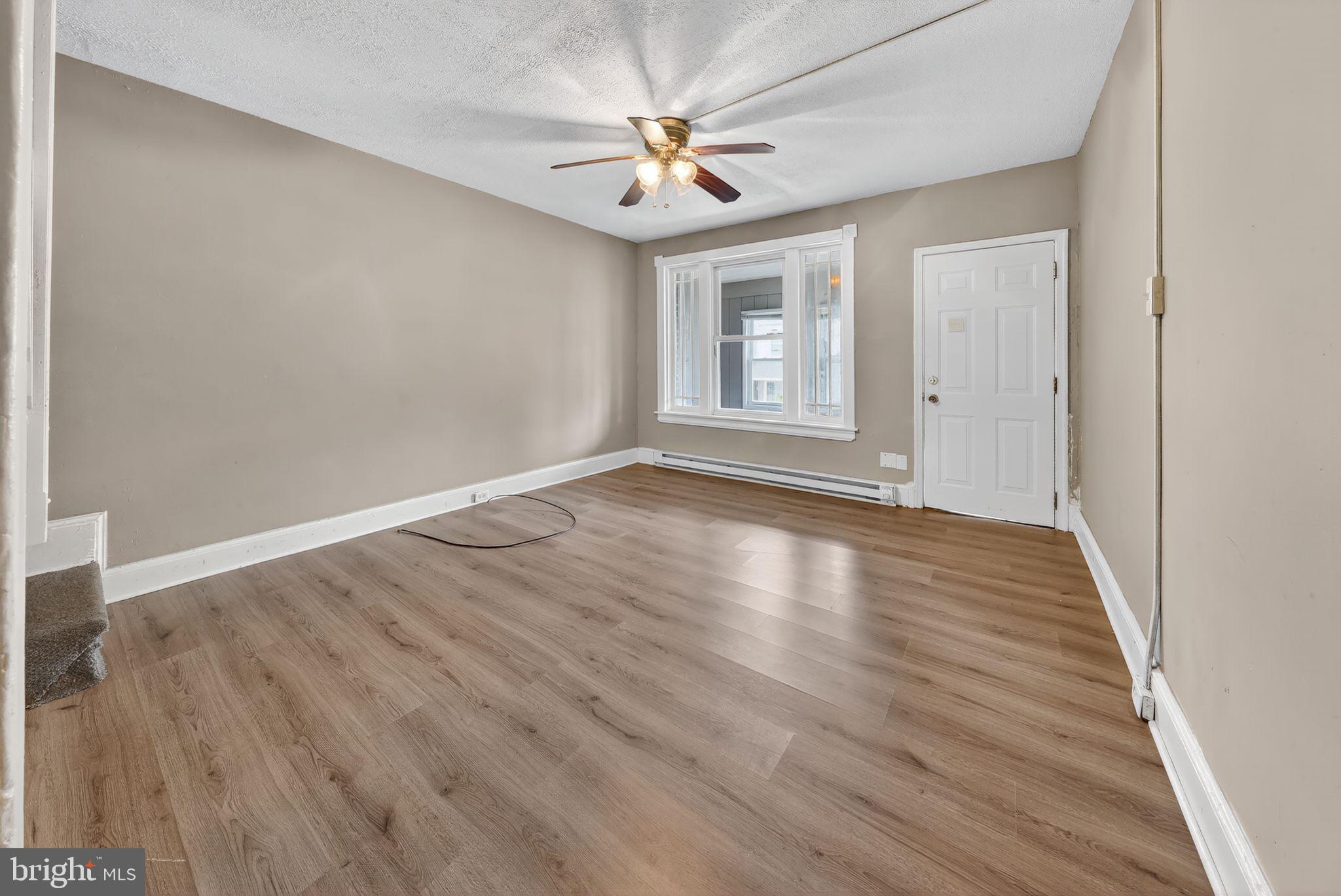11 East 24th Street Wilmington, DE 19802 - Photo 9 of 31 wooden floor in an empty room with a window