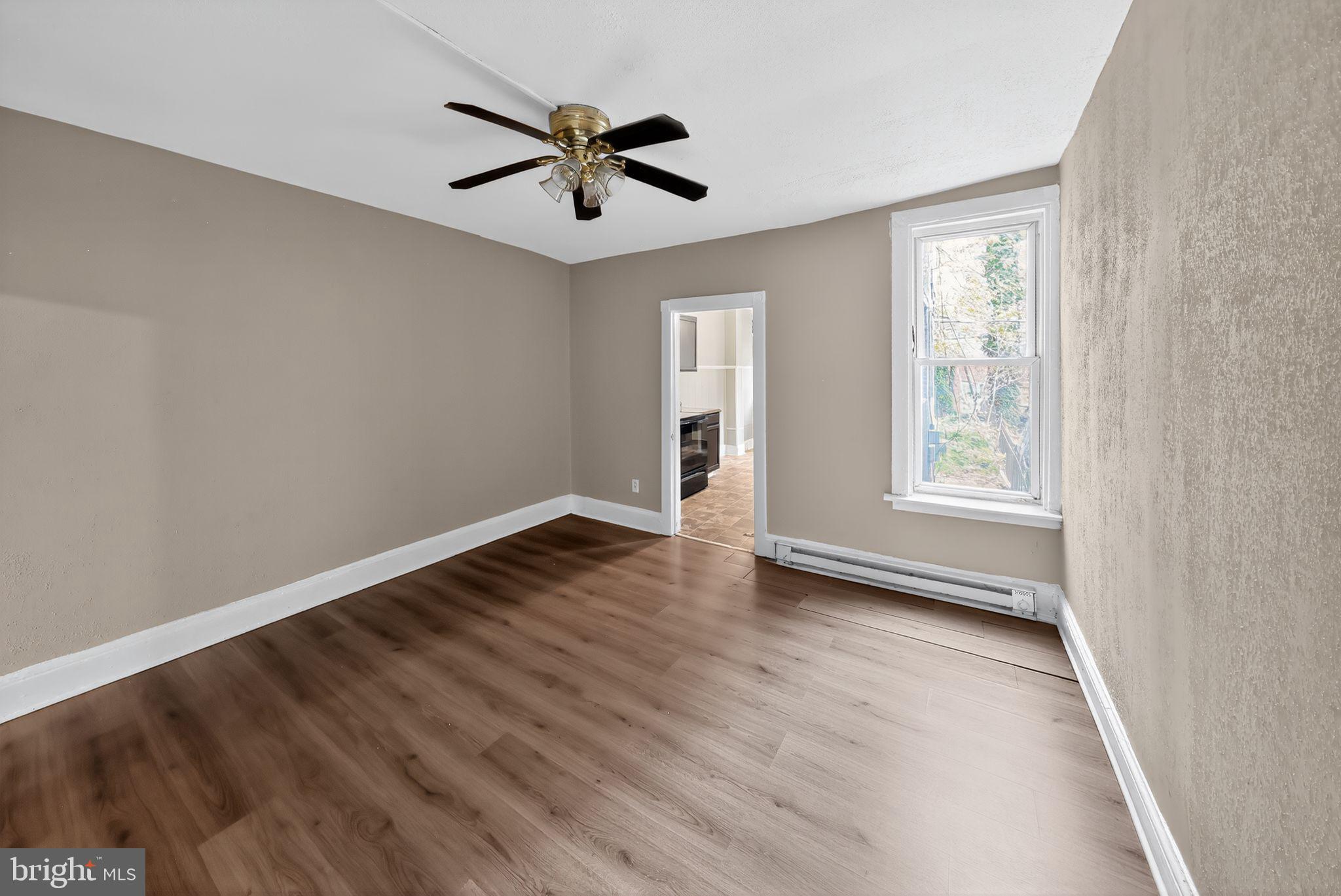 11 East 24th Street Wilmington, DE 19802 - Photo 10 of 31 an empty room with wooden floor and windows