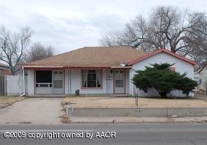 1409 Southwest 34th Avenue Amarillo, TX 79109 - Photo 1 of 11 front view of a house with a bench