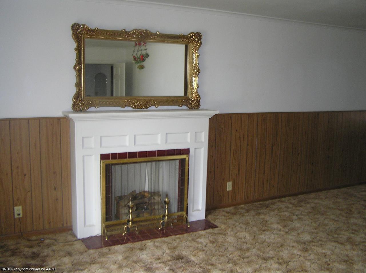 1409 Southwest 34th Avenue Amarillo, TX 79109 - Photo 11 of 11 a view of a livingroom with a fireplace and dresser