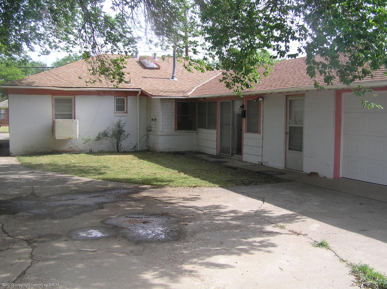 1409 Southwest 34th Avenue Amarillo, TX 79109 - Photo 2 of 11 a front view of a house with a yard and a garage