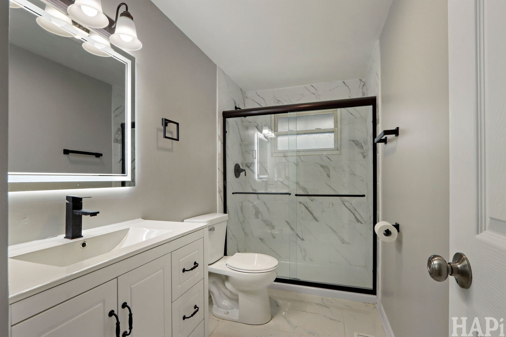 1835 West Weathersfield Way Schaumburg, IL 60193 - Photo 15 of 54 a bathroom with a toilet a sink a mirror and shower