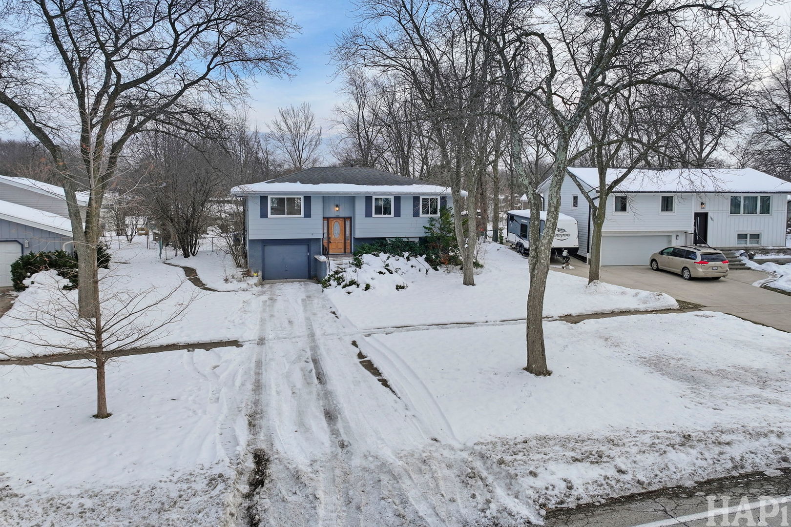 1835 West Weathersfield Way Schaumburg, IL 60193 - Photo 48 of 54 a front view of a house with a yard covered with snow