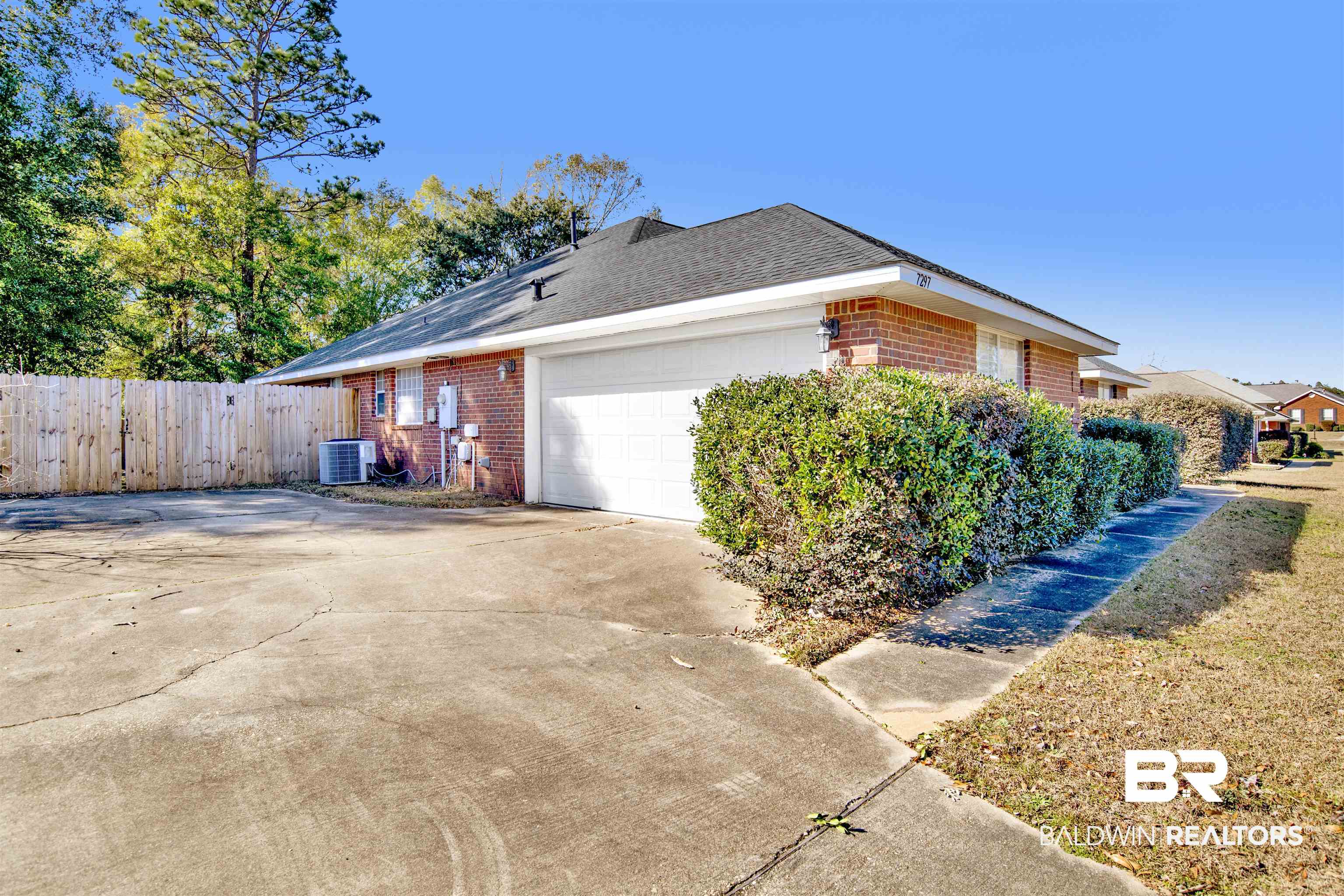 7297 Bridgemill Drive Mobile, AL 36619 - Photo 31 of 33 View of property exterior with brick siding, driveway, a garage, and roof with shingles