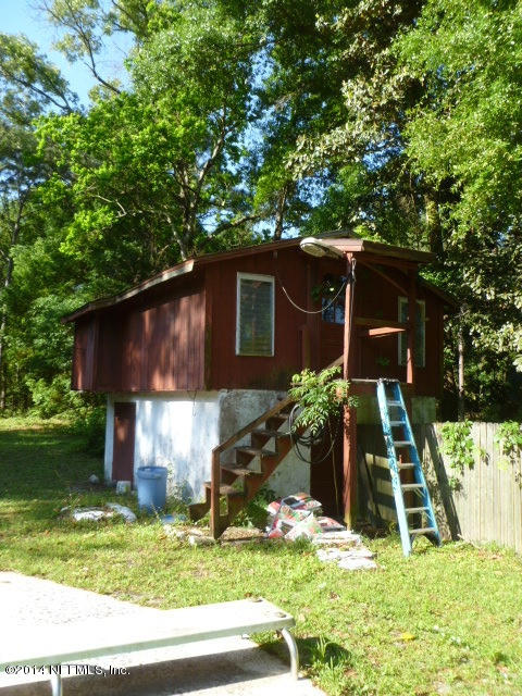 9752 Cunningham Road Jacksonville, FL 32246 - Photo 4 of 12 a front view of a house with a yard