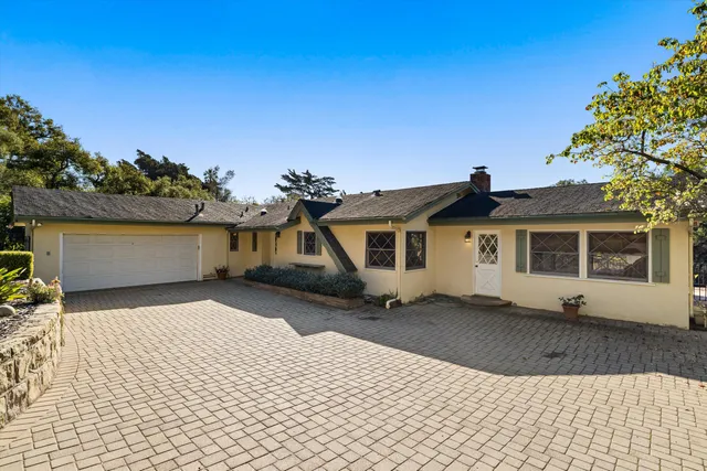a view of a patio with a table and chairs