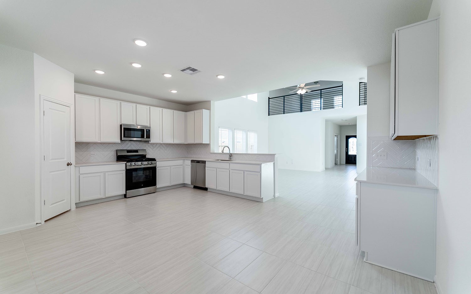 425 Monarch Trail Huntsville, TX 77340 - Photo 9 of 19 a kitchen with white cabinets and stainless steel appliances