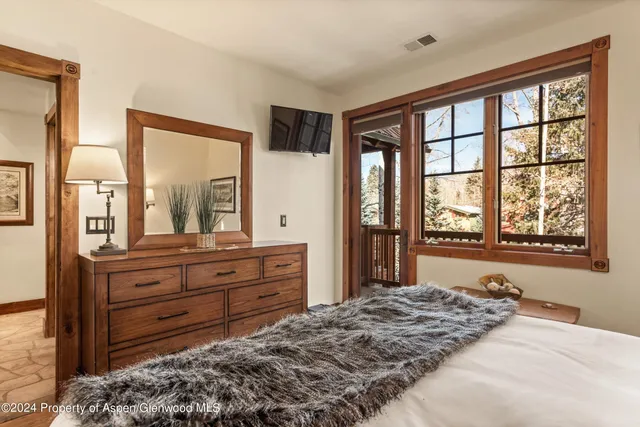 a bed room with a bed and a large window