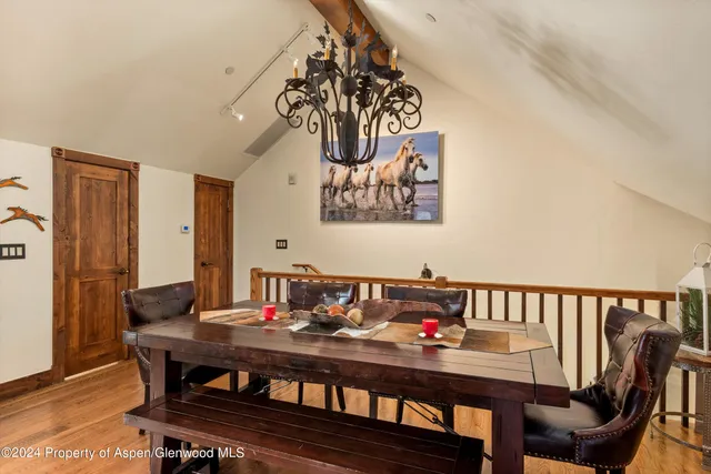 a view of a dining room with furniture wooden floor and a chandelier