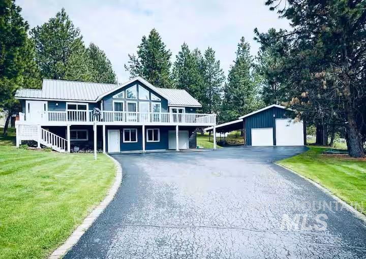 126 Par Drive Cascade, ID 83611 - Photo 2 of 45 View of front of home with a front yard, a wooden deck, and a metal roof