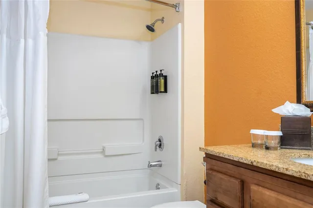 a bedroom with two beds and painting on the wall