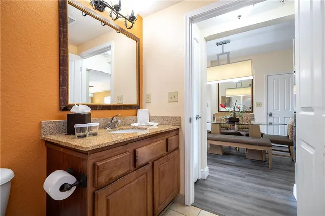 a large bed sitting in a bedroom next to a lamp