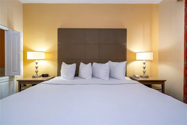 a view of a house with pool and chairs