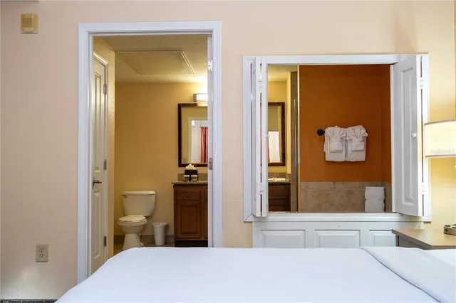 an aerial view of a house with a garden and lake view