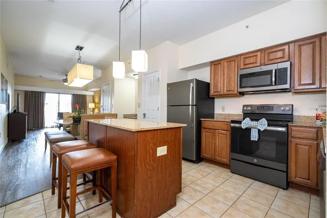 a kitchen with stainless steel appliances granite countertop a refrigerator stove top oven a sink and dishwasher