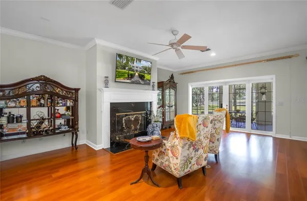 a bed sitting in a spacious bedroom next to a window