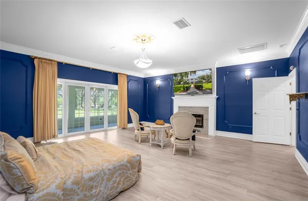 an empty room with wooden floor ceiling fan and windows