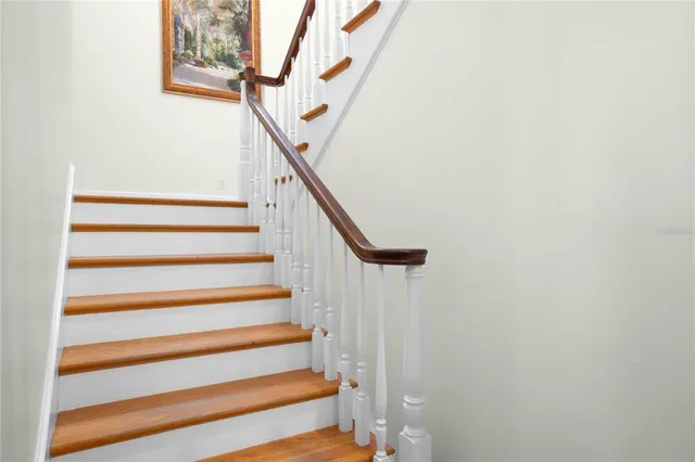 a view of a livingroom with a fireplace wooden floor and windows