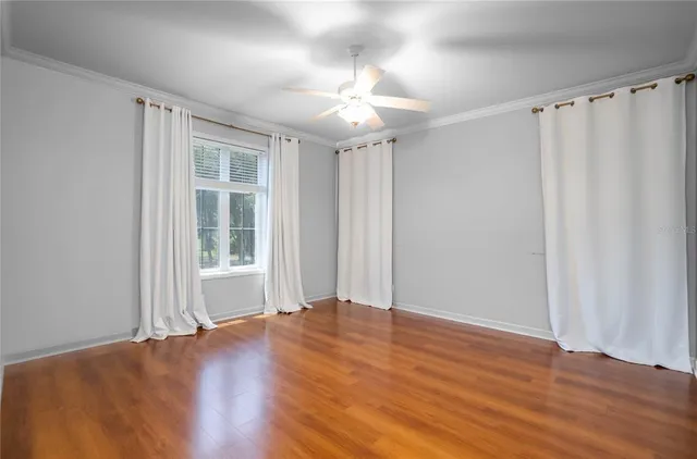 an aerial view of residential houses with outdoor space and trees all around