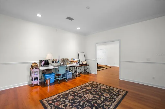 a kitchen with stainless steel appliances granite countertop stove a refrigerator a sink dishwasher and white countertops with wooden floor