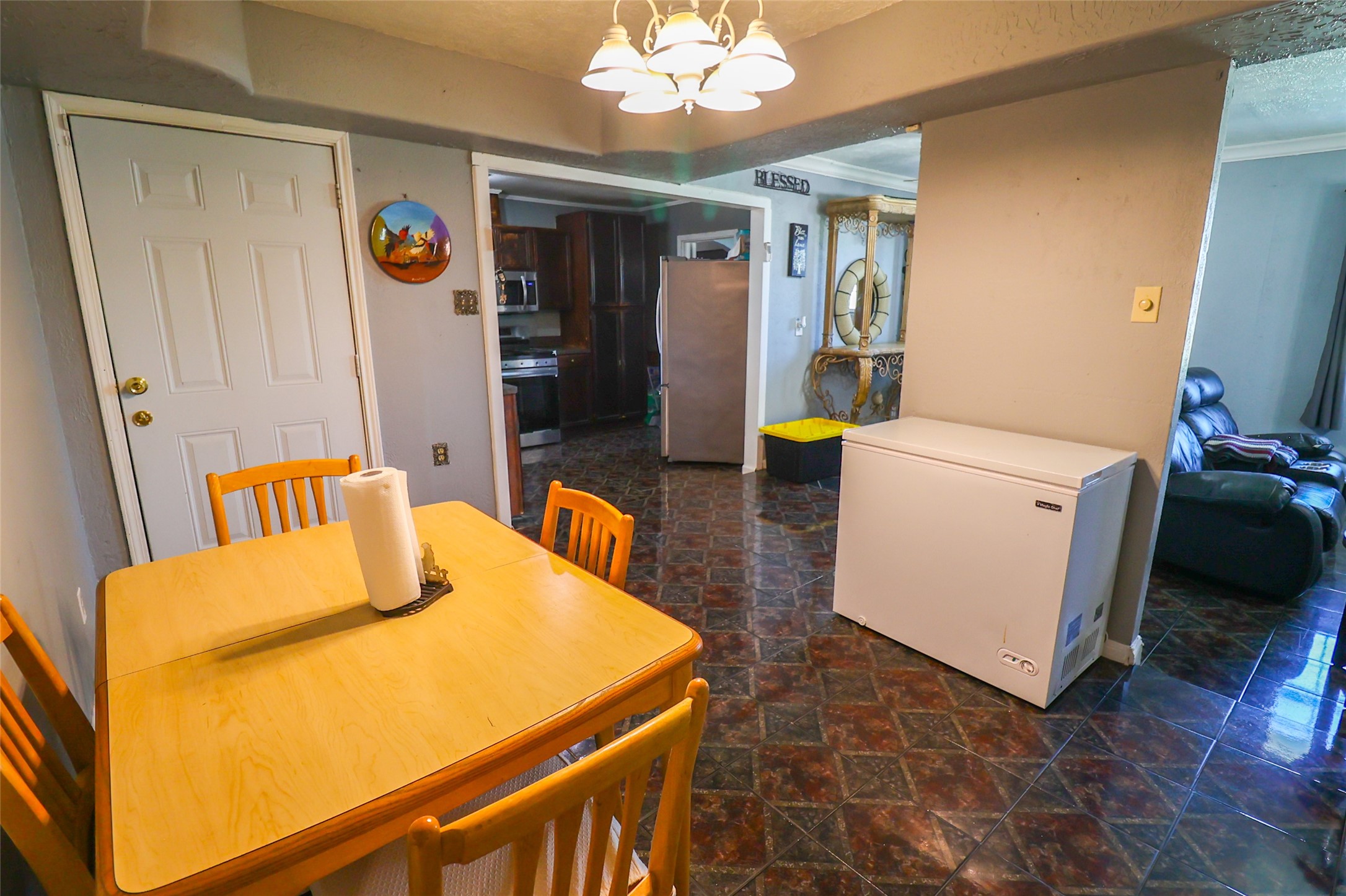 416 Clara Road South Houston, TX 77587 - Photo 12 of 50 a view of a dining room with furniture and a chandelier
