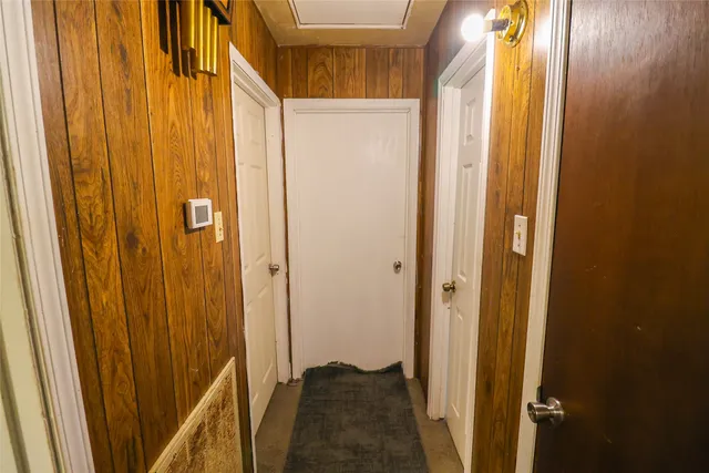 a room with walk in closet and wooden floor