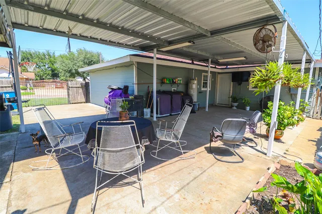 a view of a dining table and chairs in the patio
