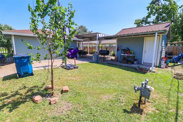 a view of a patio with table and chairs under an umbrella