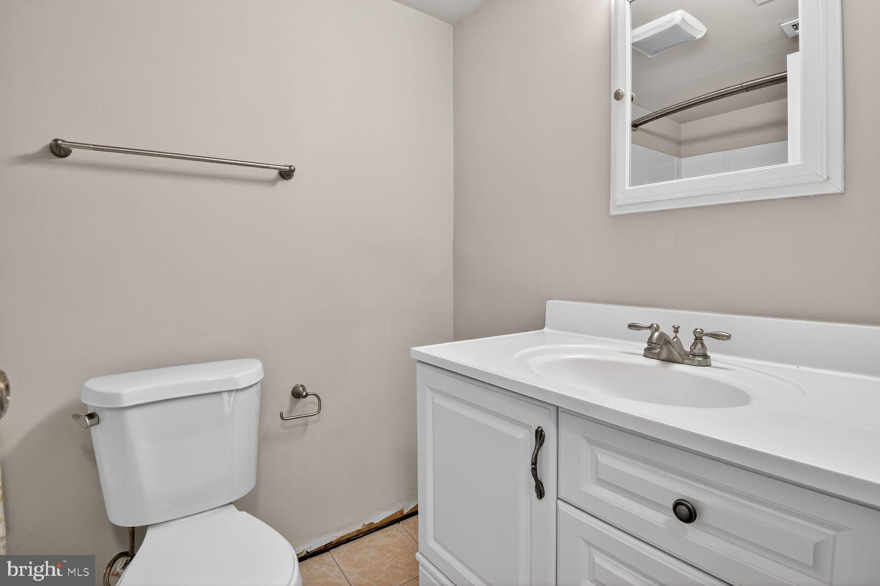 2907 Charing Cross Road, Unit 14 Falls Church, VA 22042 - Photo 14 of 15 a bathroom with a toilet sink and mirror