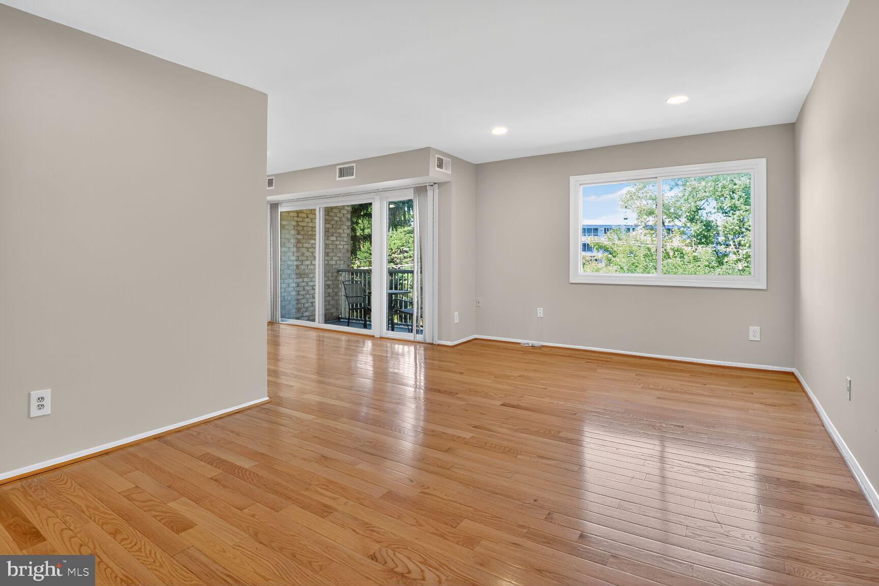 2907 Charing Cross Road, Unit 14 Falls Church, VA 22042 - Photo 2 of 15 a view of an empty room with wooden floor and a window