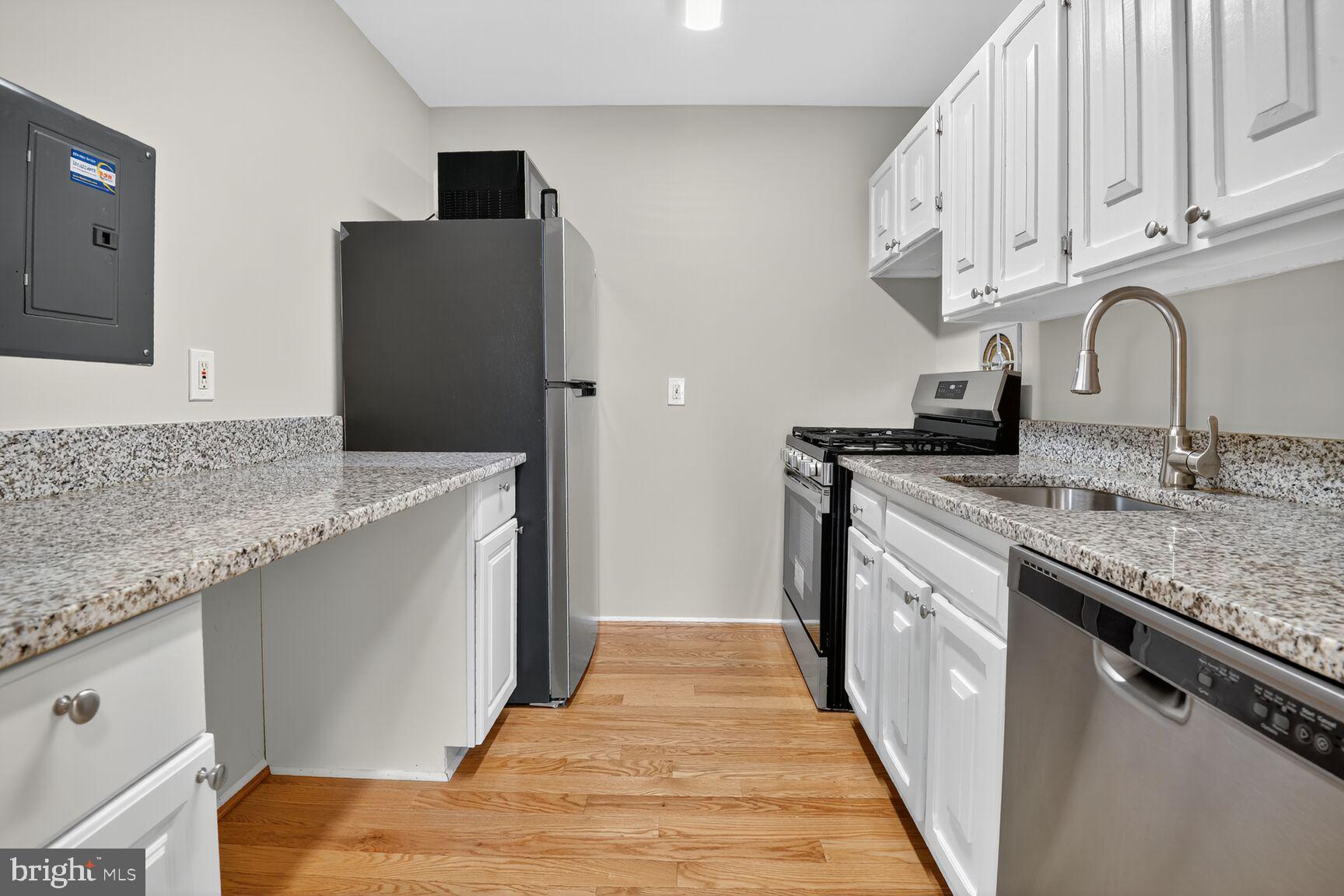 2907 Charing Cross Road, Unit 14 Falls Church, VA 22042 - Photo 9 of 15 a kitchen with granite countertop a sink and a refrigerator