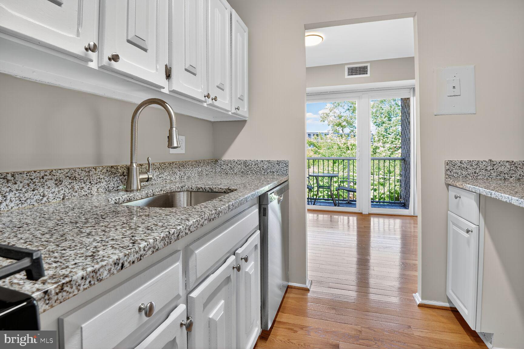 2907 Charing Cross Road, Unit 14 Falls Church, VA 22042 - Photo 10 of 15 a kitchen with stainless steel appliances granite countertop a sink stove and cabinets