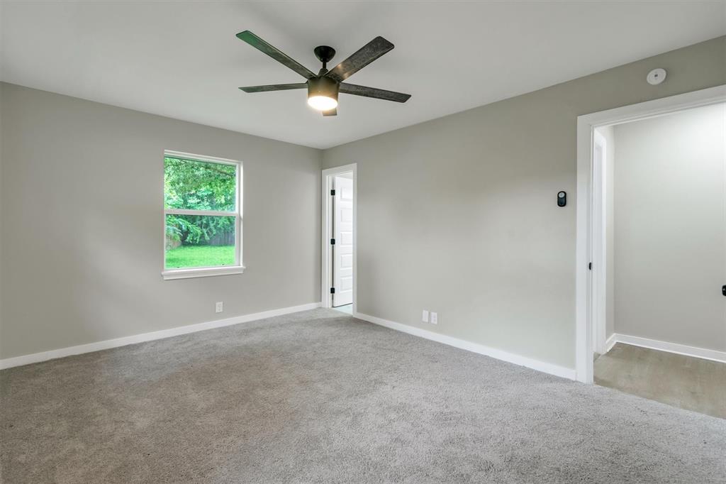 4815 Kelman Street Dallas, TX 75214 - Photo 21 of 37 Room featuring neutral gray walls and gray carpet flooring