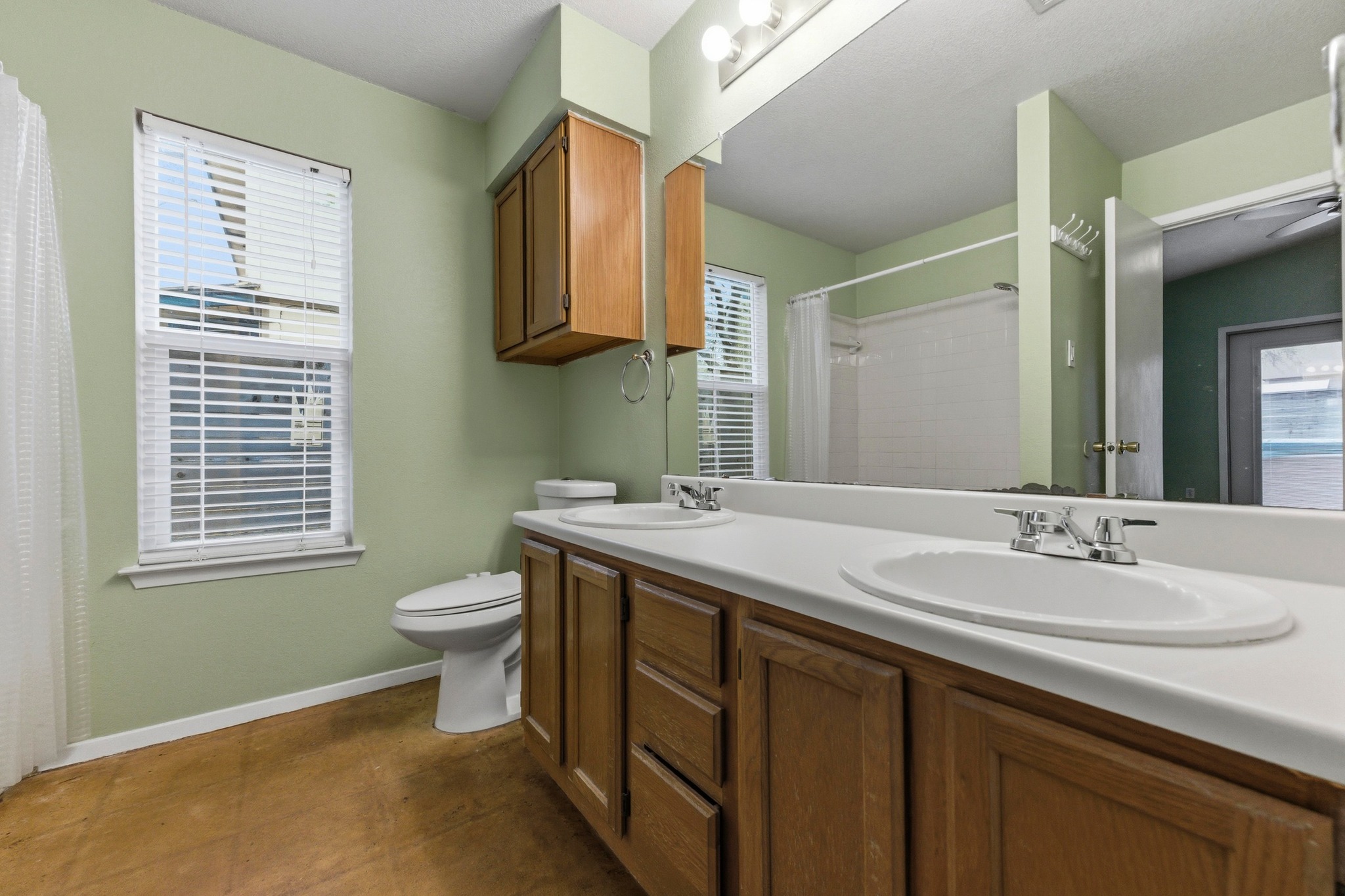 723 Shade Tree Drive Austin, TX 78748 - Photo 12 of 29 a bathroom with a sink a toilet and a mirror