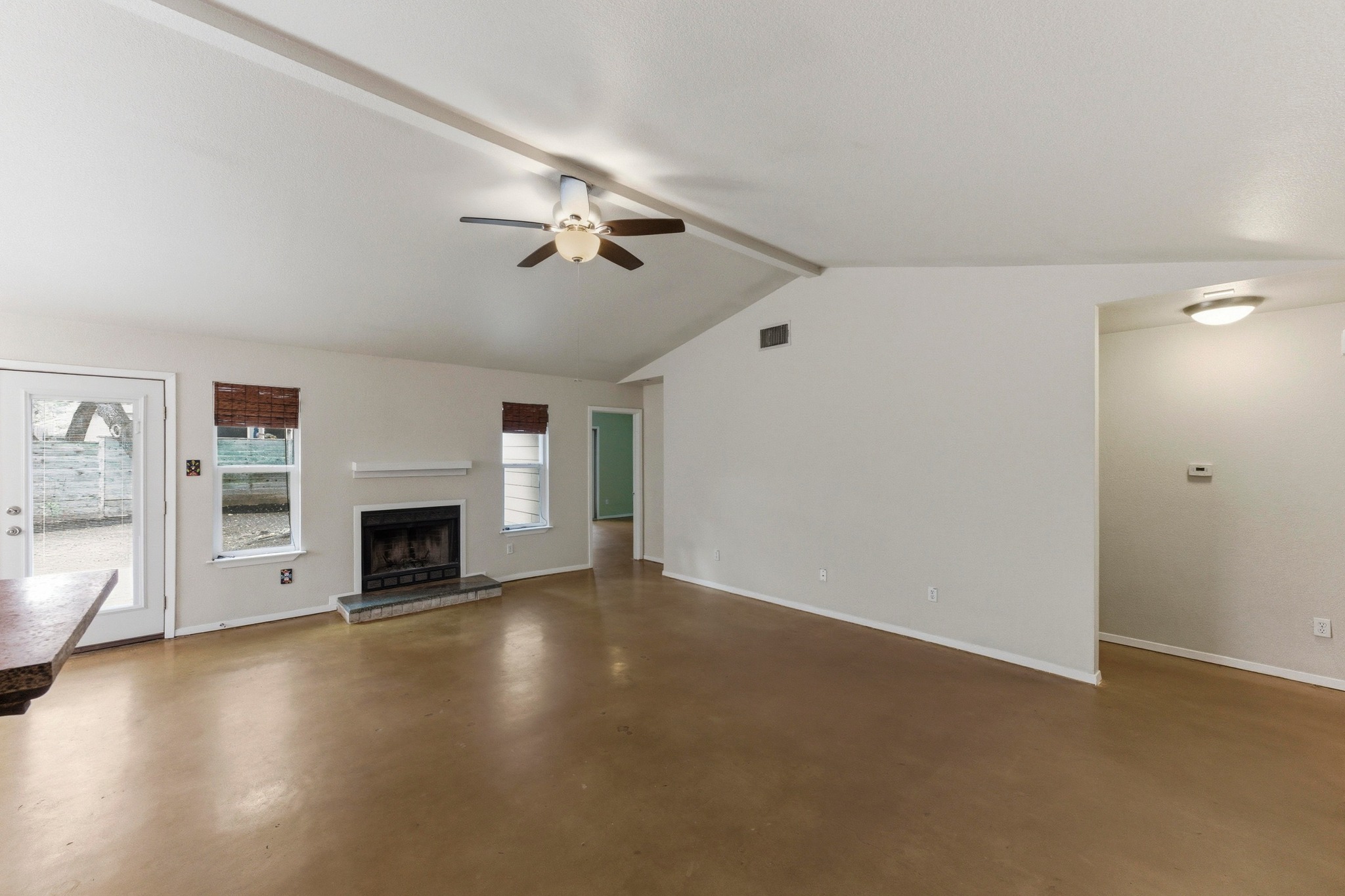 723 Shade Tree Drive Austin, TX 78748 - Photo 4 of 29 a view of empty room with fireplace and wooden floor