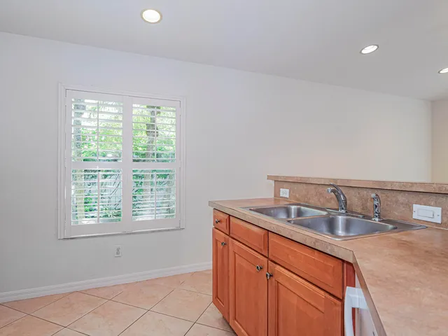 a kitchen with a sink cabinets and window