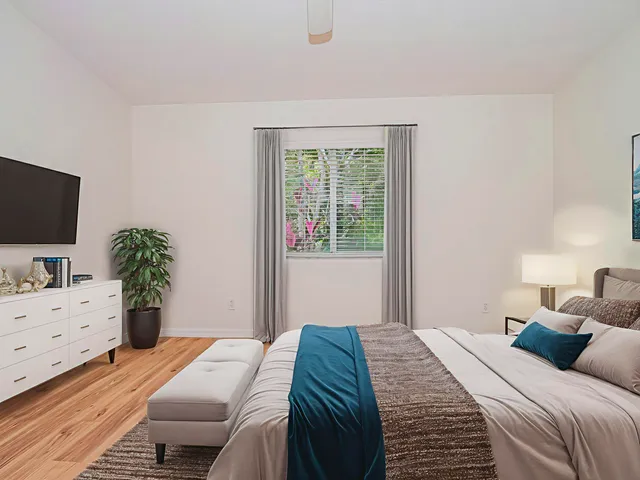 a bedroom with a bed and a flat screen tv