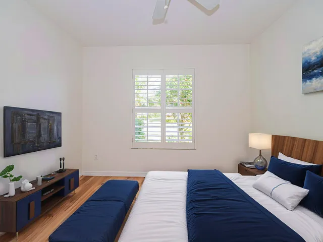 a bed room with a bed window and a television