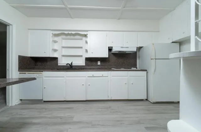 a view of cabinets with wooden floor