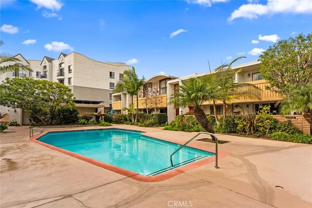 a view of swimming pool with outdoor seating and city view