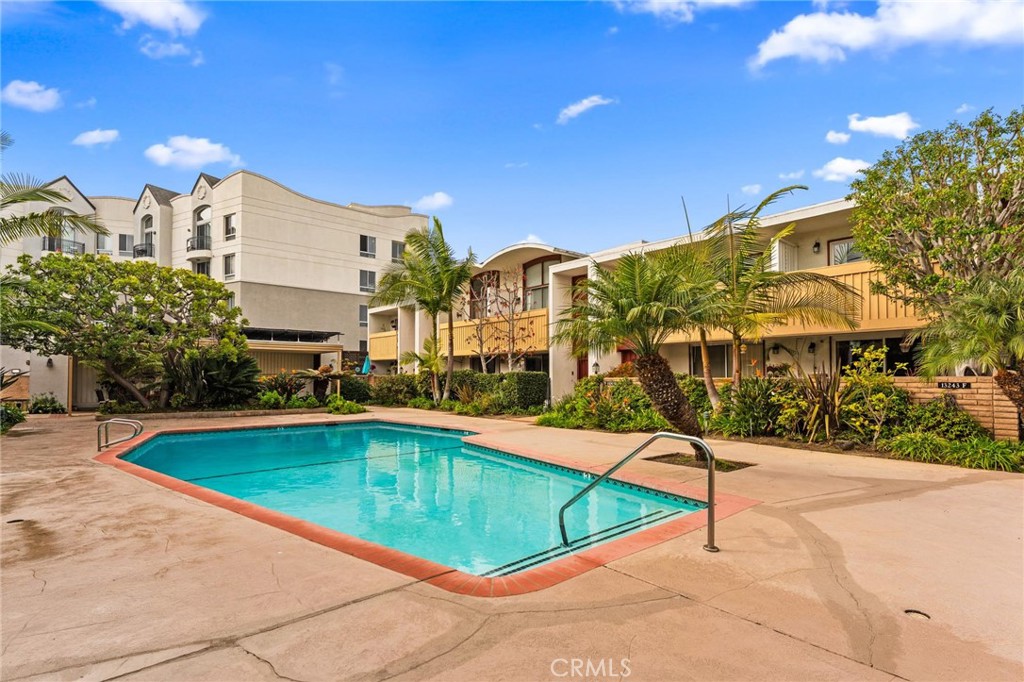 a view of swimming pool with outdoor seating and city view