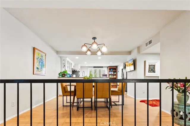 a view of a dining room with furniture and a chandelier