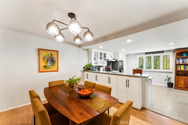 a view of a dining room with furniture a chandelier and wooden floor