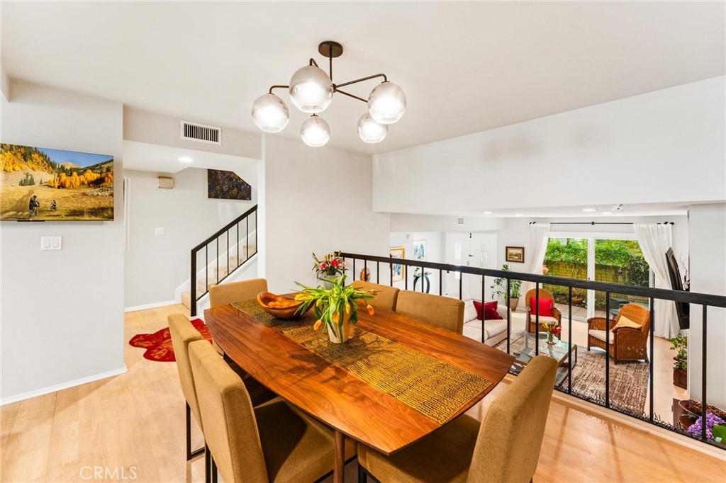 13243 Fiji Way, Unit K Marina del Rey, CA 90292 - Photo 17 of 39 a view of a dining room with furniture a chandelier and wooden floor
